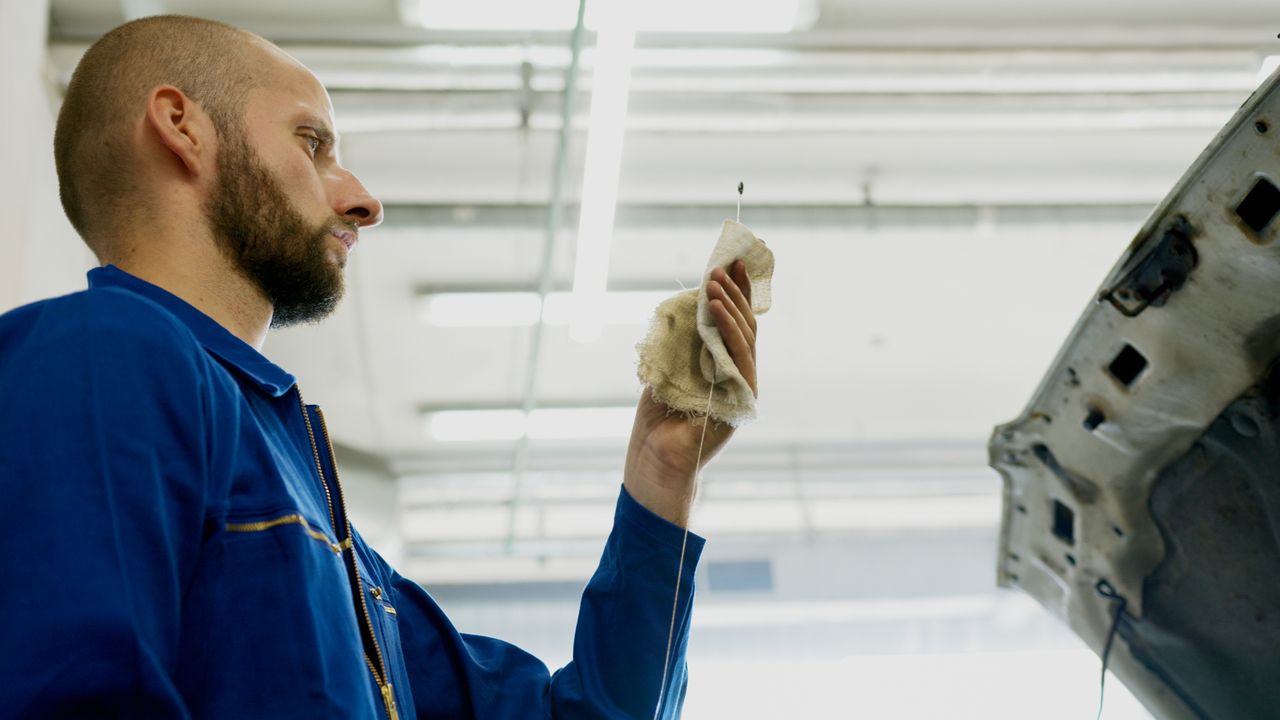 Valvoline Xpress Lube technician performing an oil change on a car