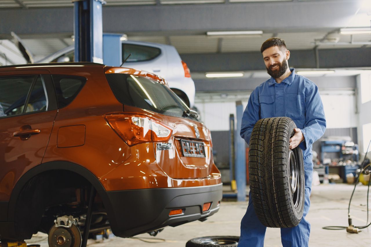 Valvoline Xpress Lube technician checking tire tread depth and pressure