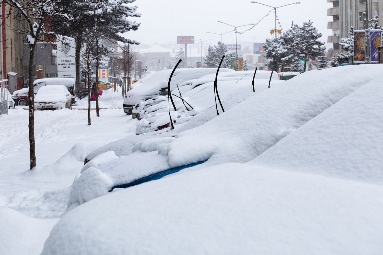 Winter tires on a car in snowy Vermont with snow-covered road